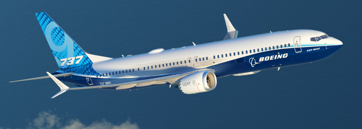 A Boeing 737 MAX 9 aircraft flying in blue sky.