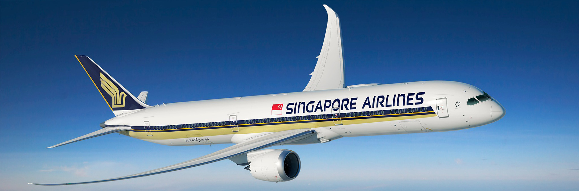 A Singapore Airlines Boeing 787 aircraft flying in blue sky.